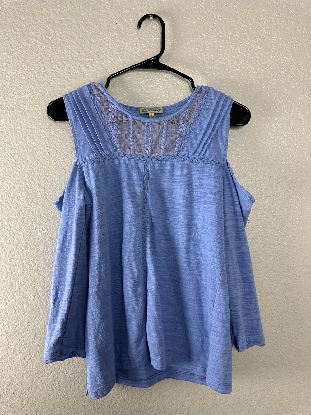 Democracy Blue blouse features delicate lace trim and a cold-shoulder design Sm